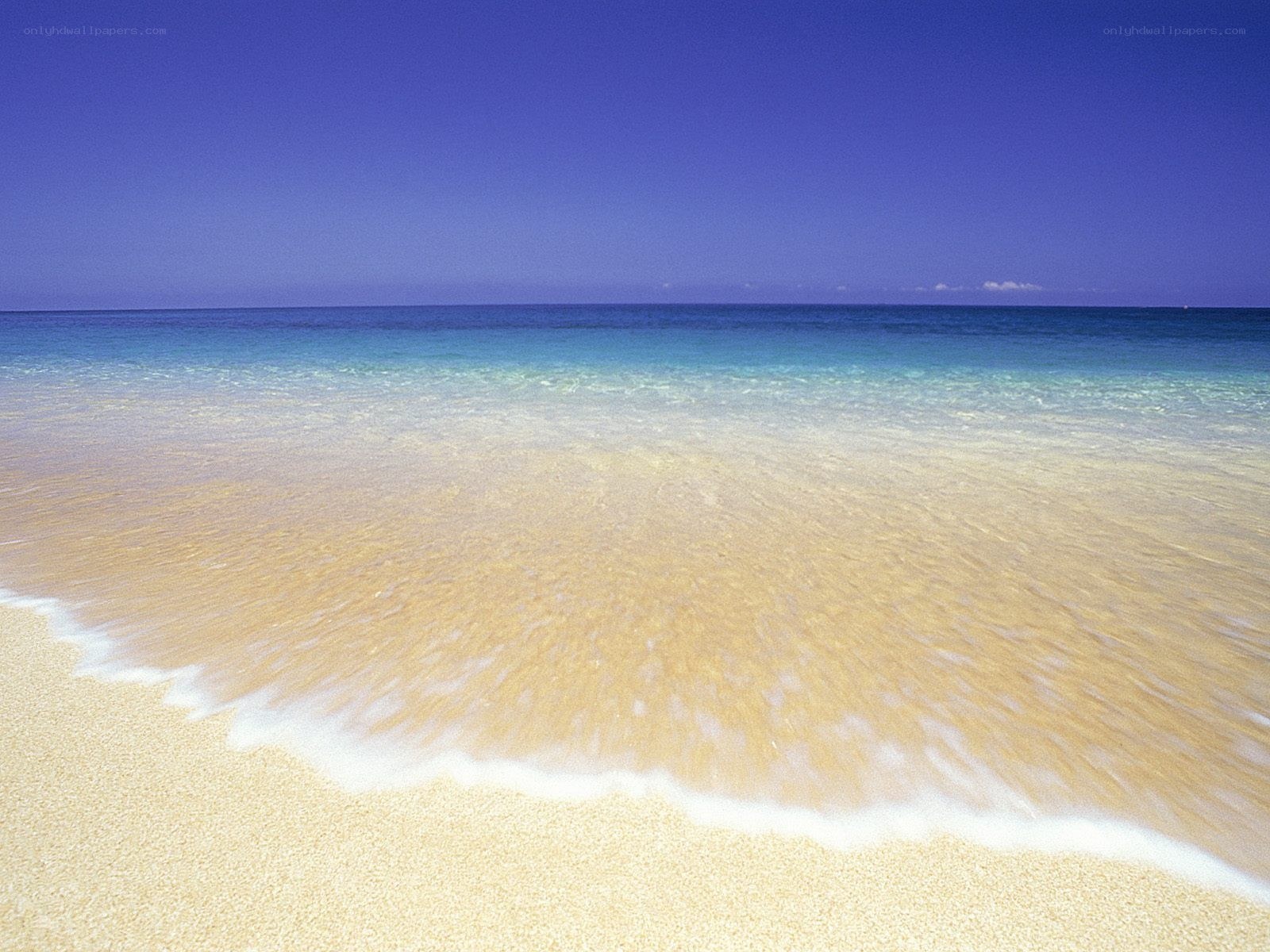 Sandy beach with clear waves