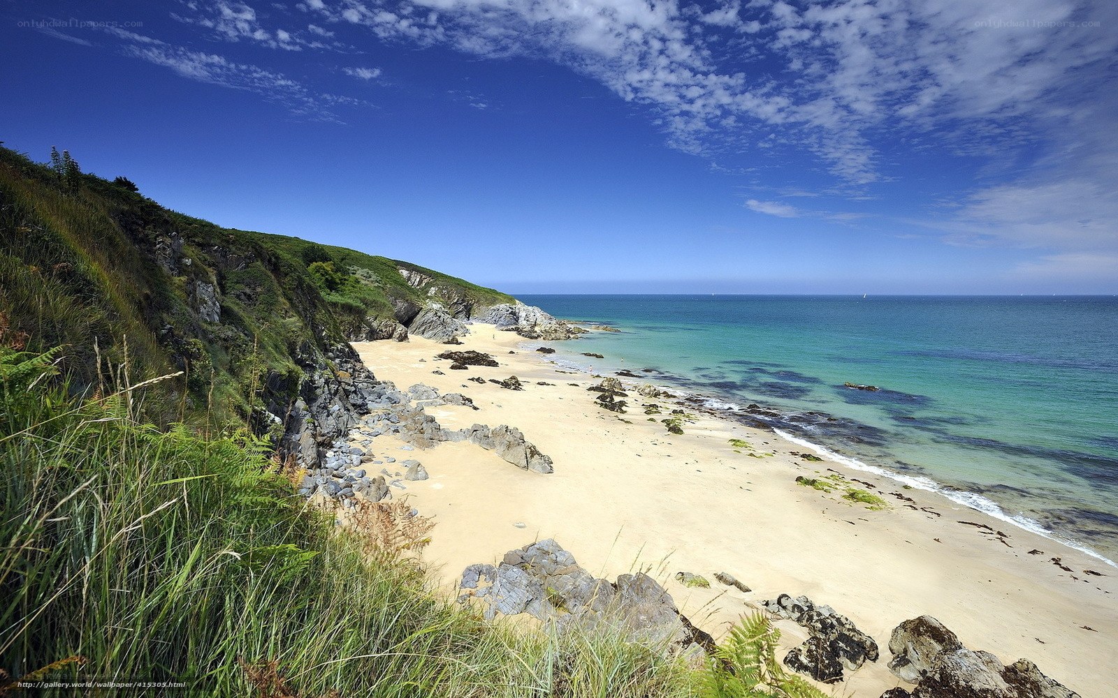sandy beach with cliffs and blue sea
