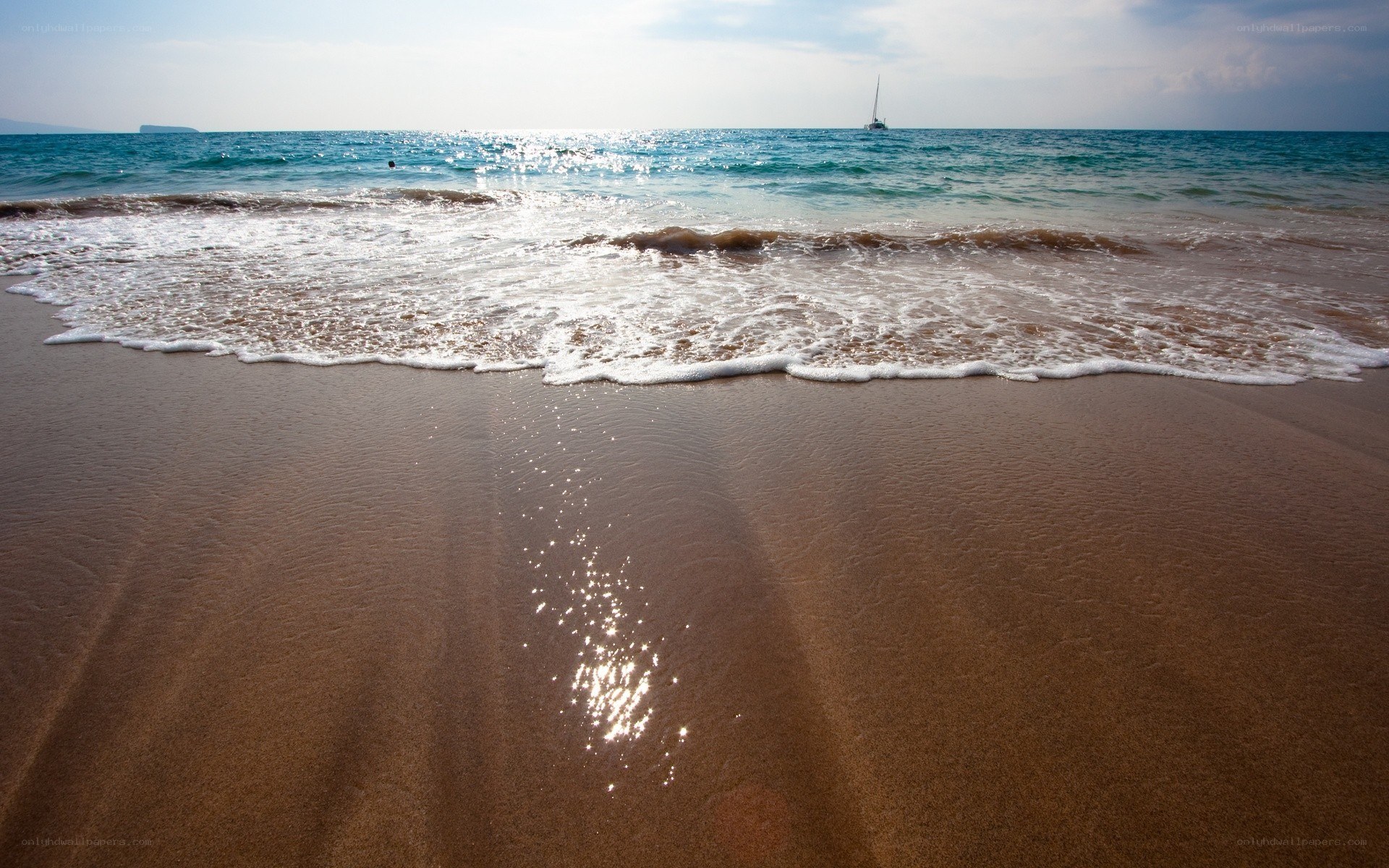 Sandy beach with gentle waves