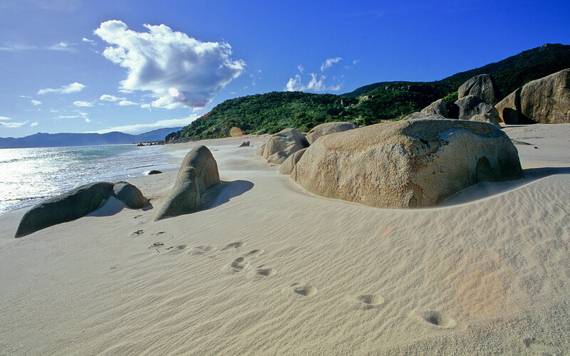 sandy beach with large rocks
