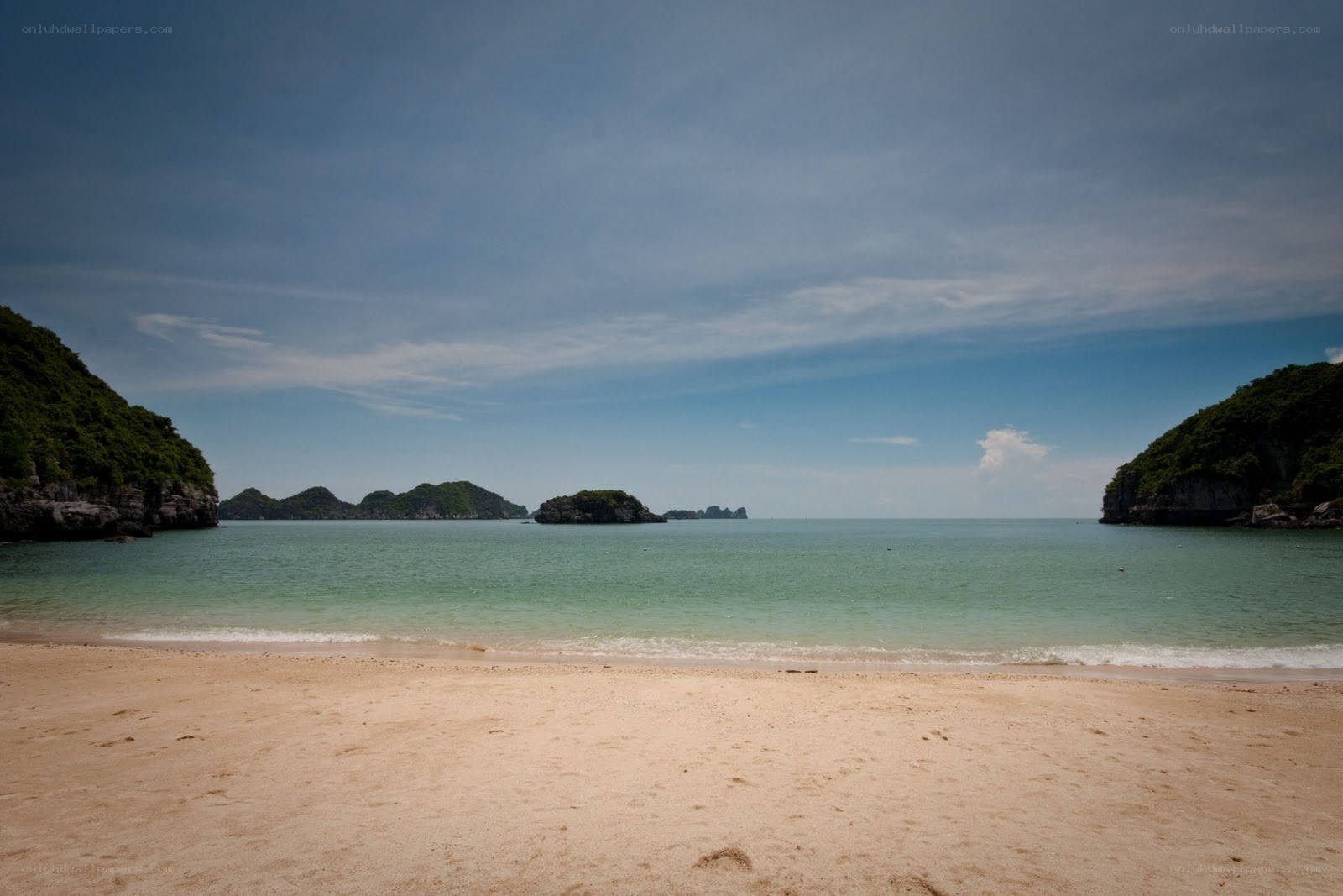 sandy beach with limestone islands