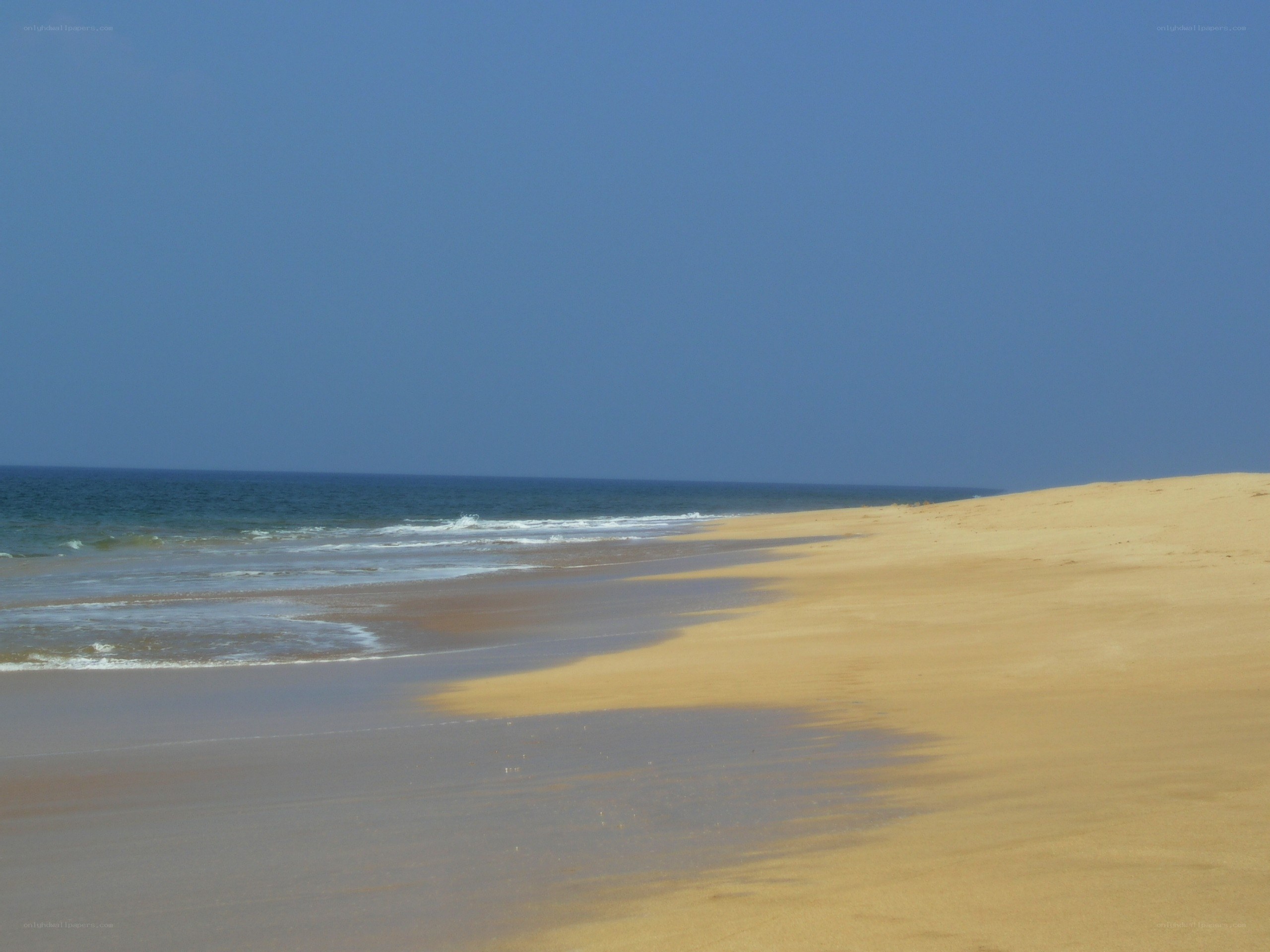 sandy beach with ocean waves