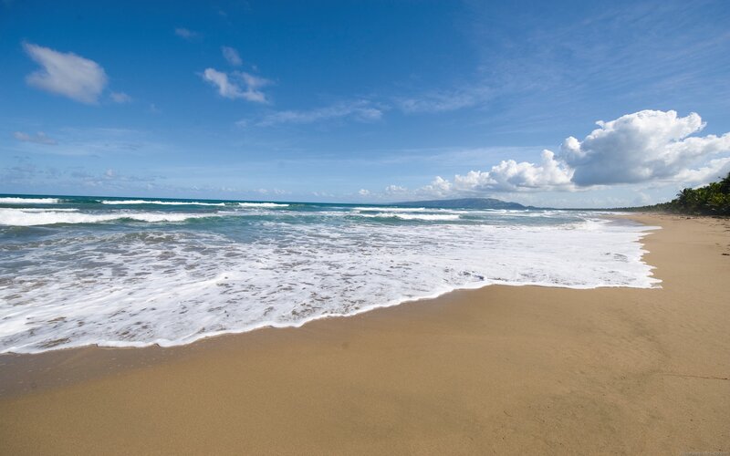 sandy beach with ocean waves