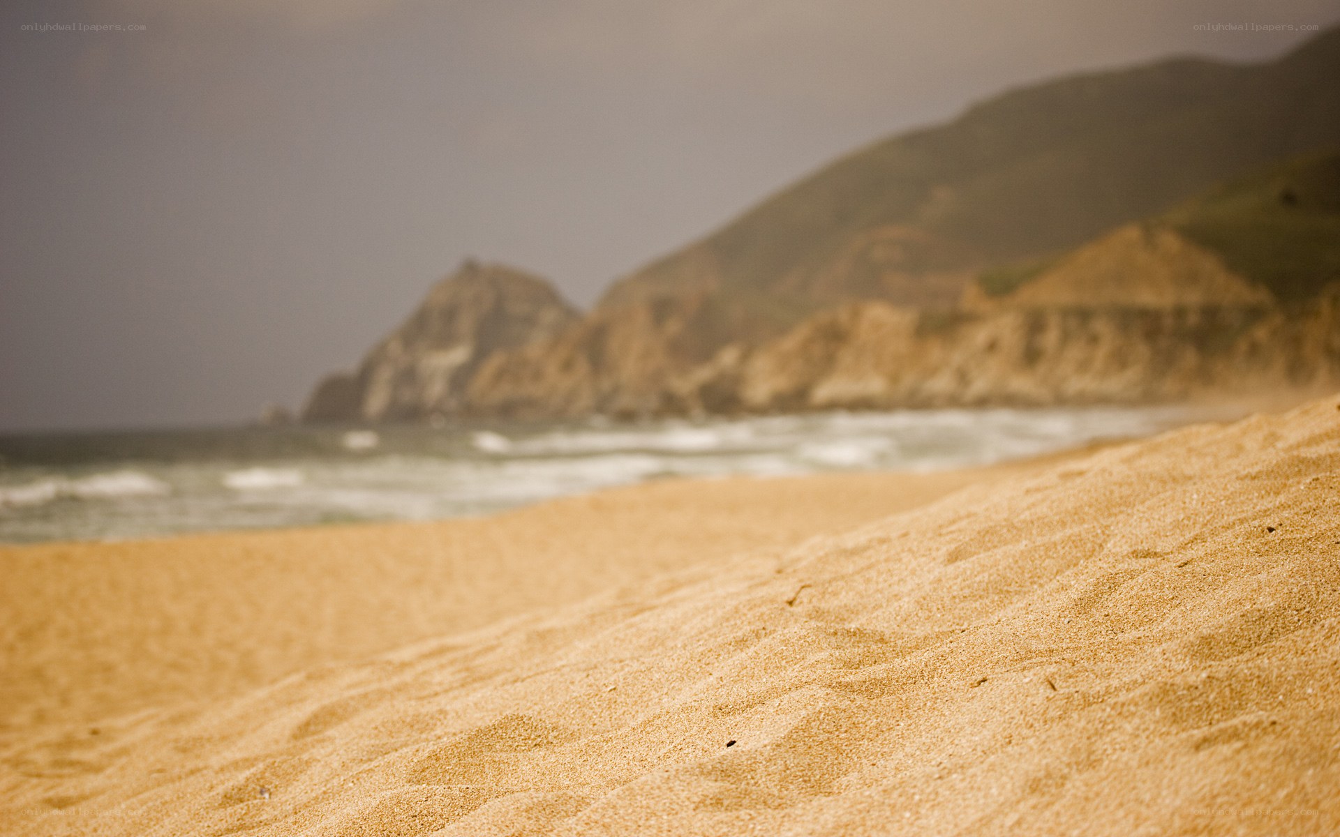 sandy beach with ocean waves
