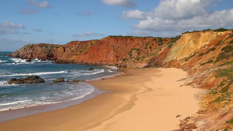 sandy beach with red cliffs