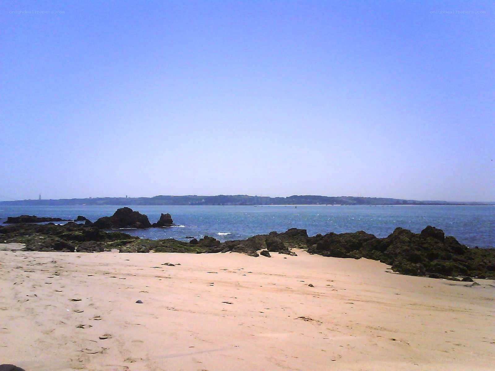 sandy beach with rocky outcrops