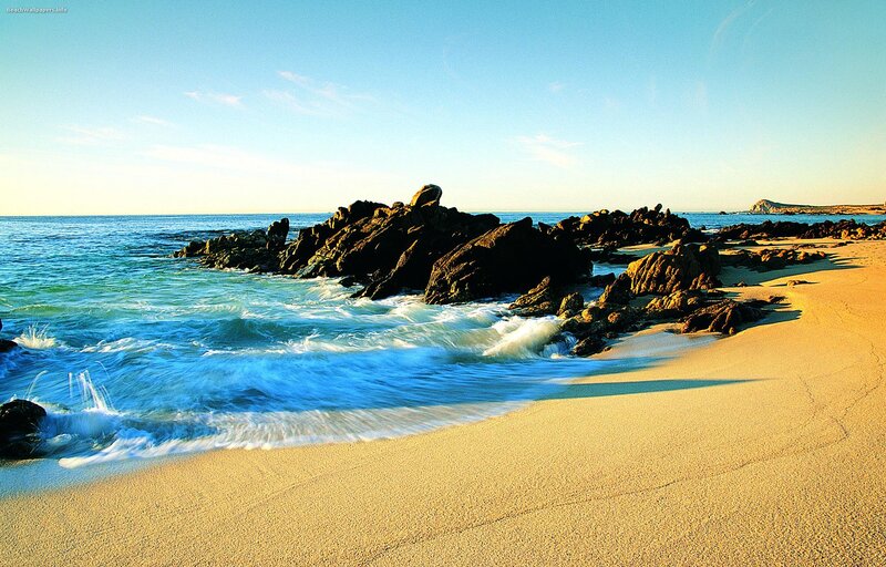 sandy beach with rocky shore