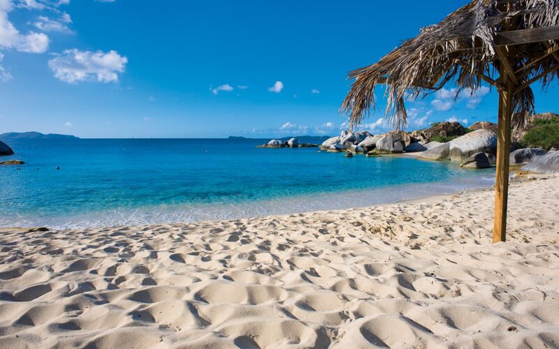 Sandy Beach with Thatched Umbrella