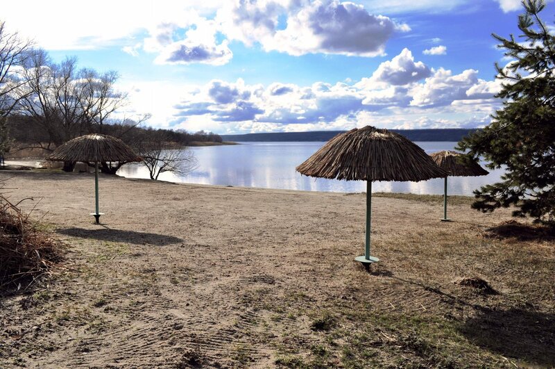 Sandy beach with thatched umbrellas