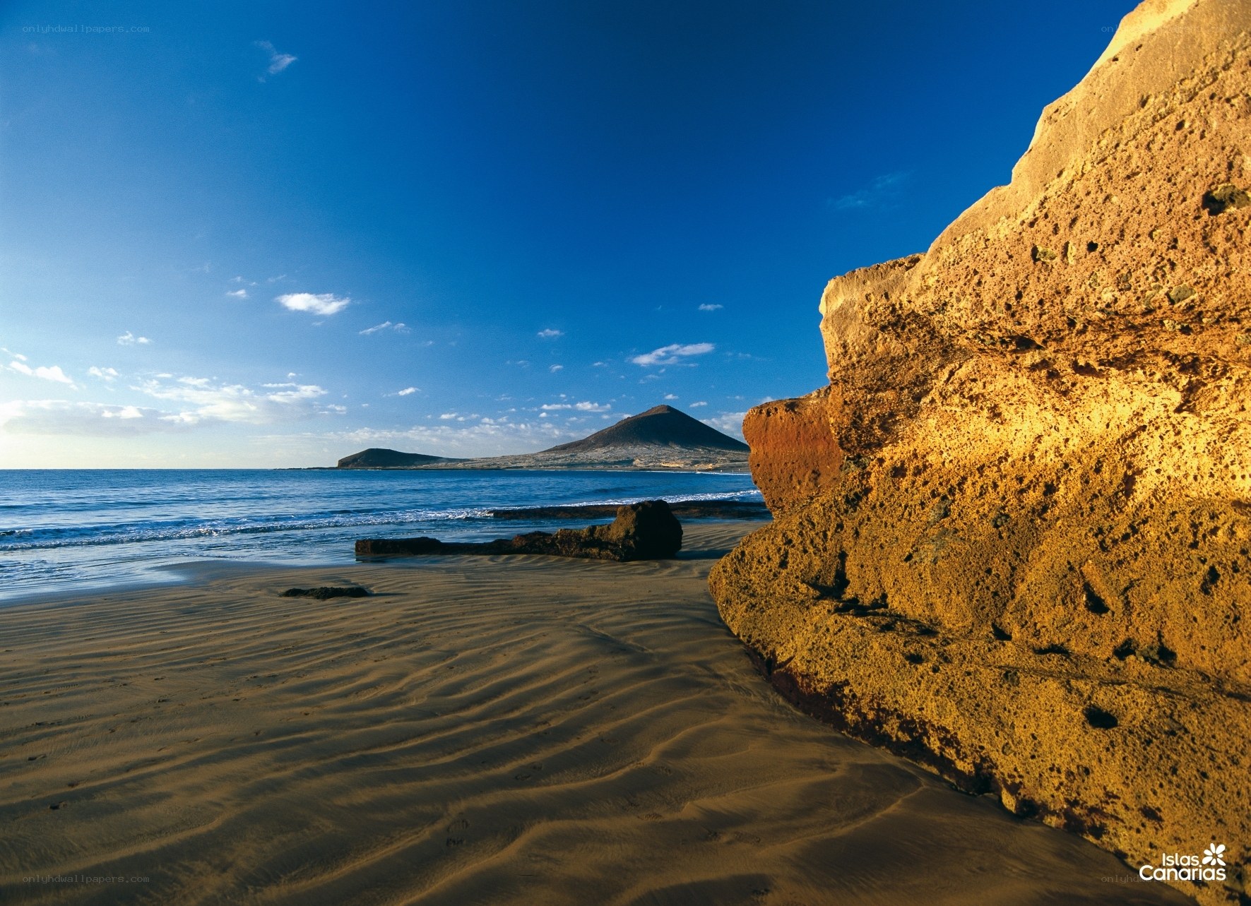 Sandy beach with volcanic rock