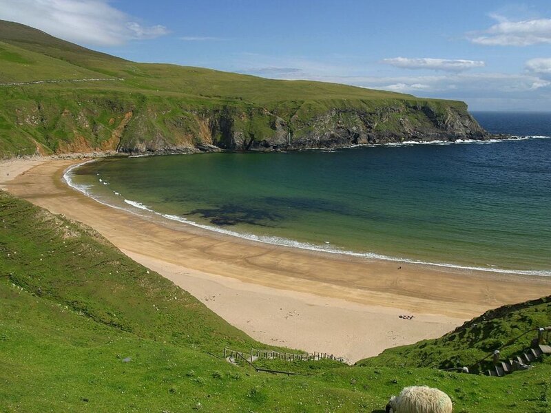 sandy cove on green cliffs
