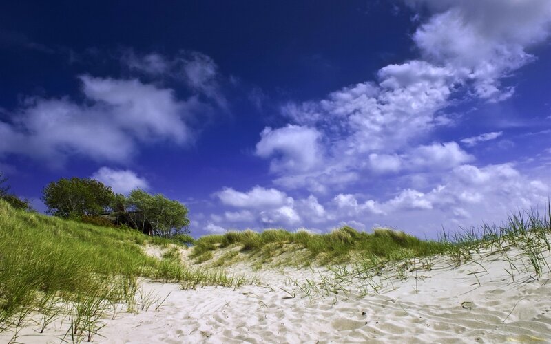 Sandy dunes under blue sky
