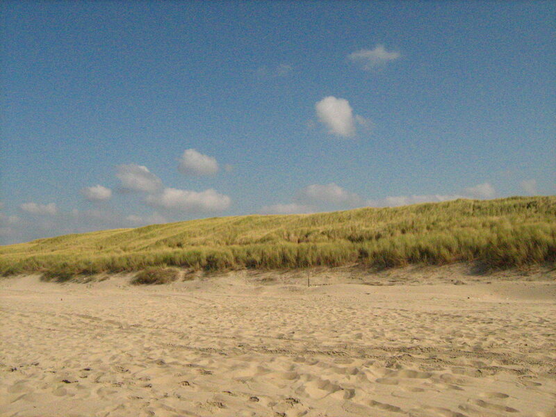 Sandy dunes under blue sky