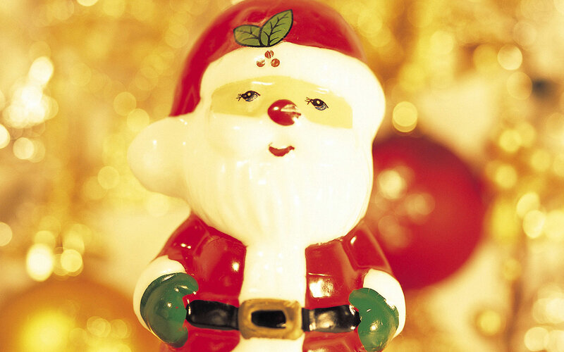 Santa Claus figurine with holly
