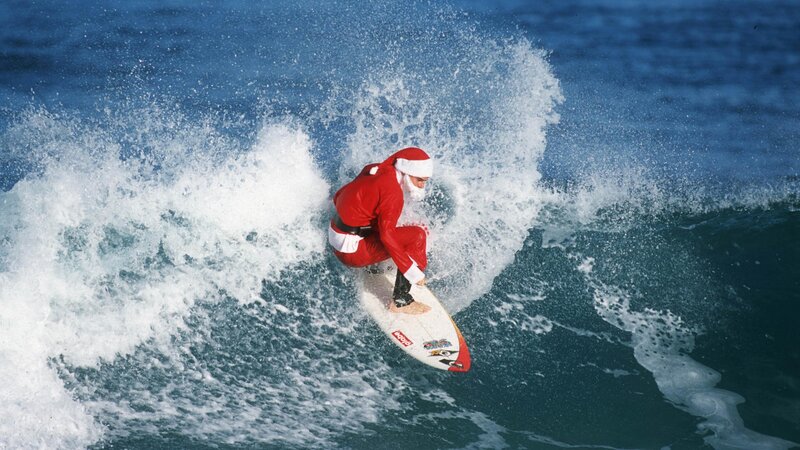 Santa Claus surfing a wave