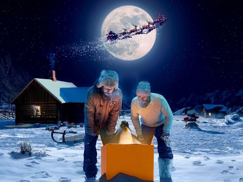 Santa flying over a snowy village