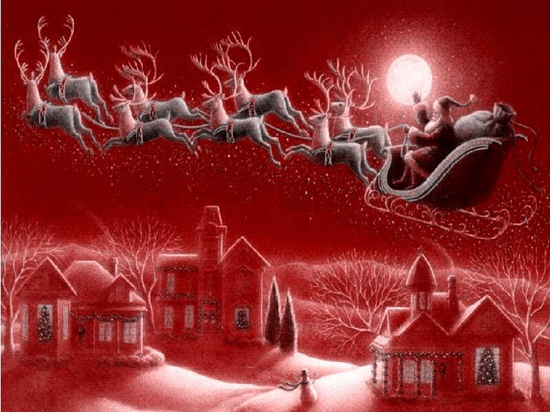 Santa flying over a snowy village