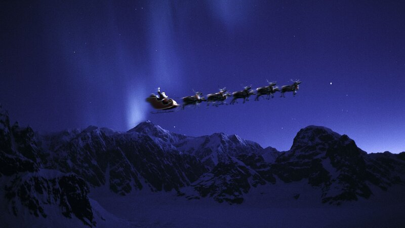 Santa flying over mountains