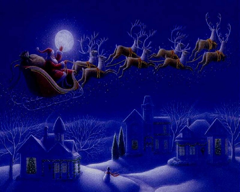 Santa flying over snowy village