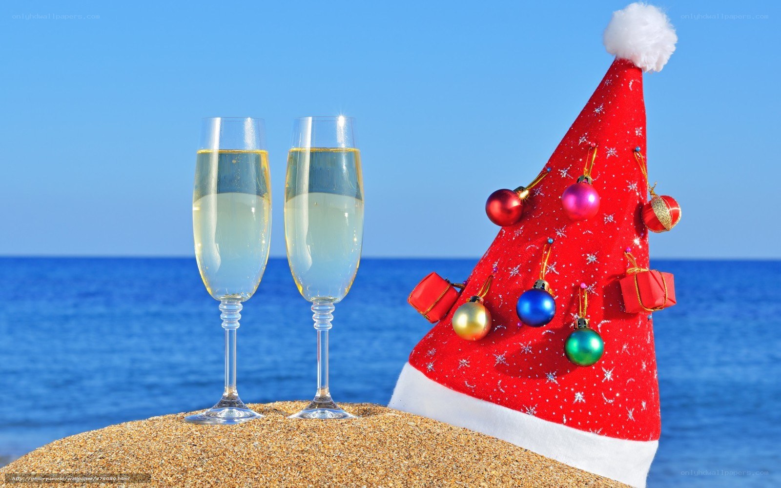 Santa hat on beach with champagne