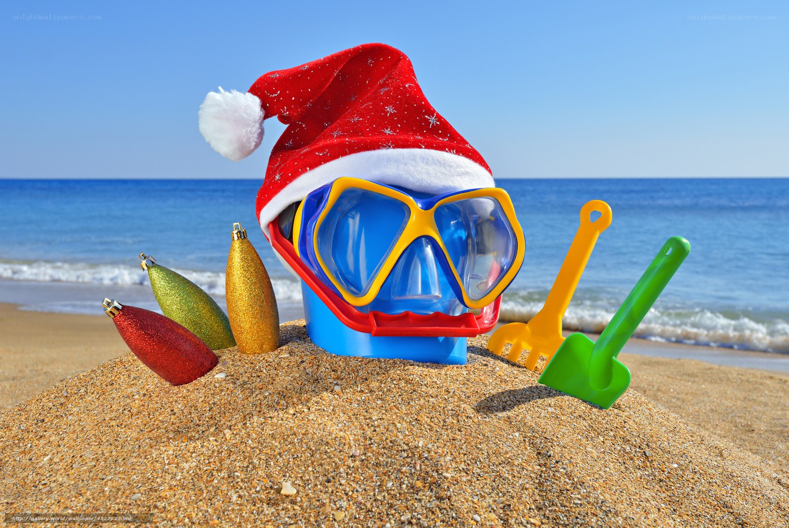 Santa hat on beach with goggles