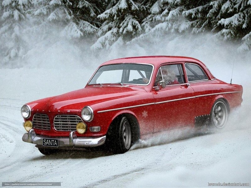 Santa in red car on snowy road