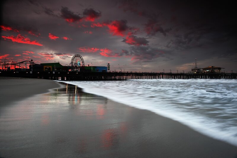 Santa Monica Pier at Dusk — Red, Dramatic, Sunset, Photograph, Ferris Wheel, Roller Coaster, Ocean Waves