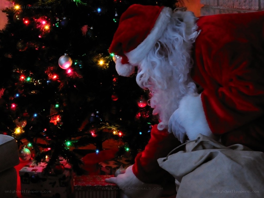 Santa placing gifts under tree