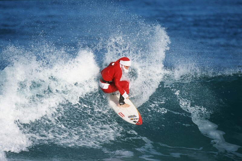 Santa surfing a wave