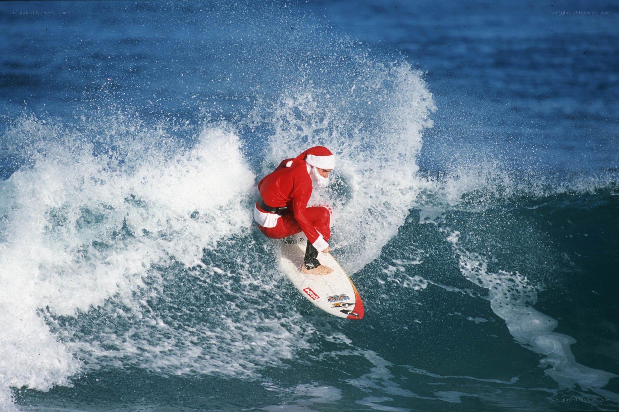 Santa surfing a wave