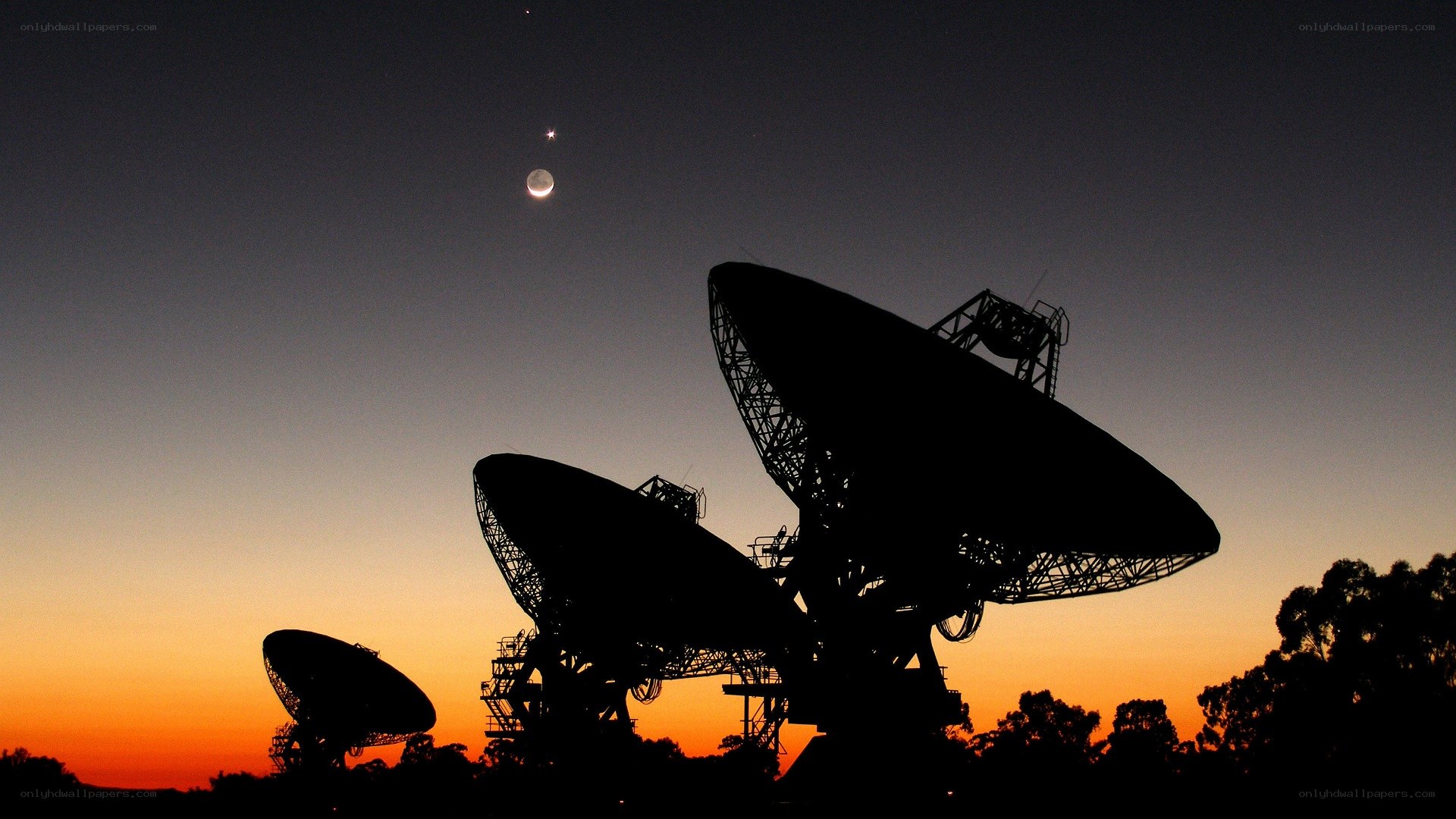 Satellite dishes at dusk