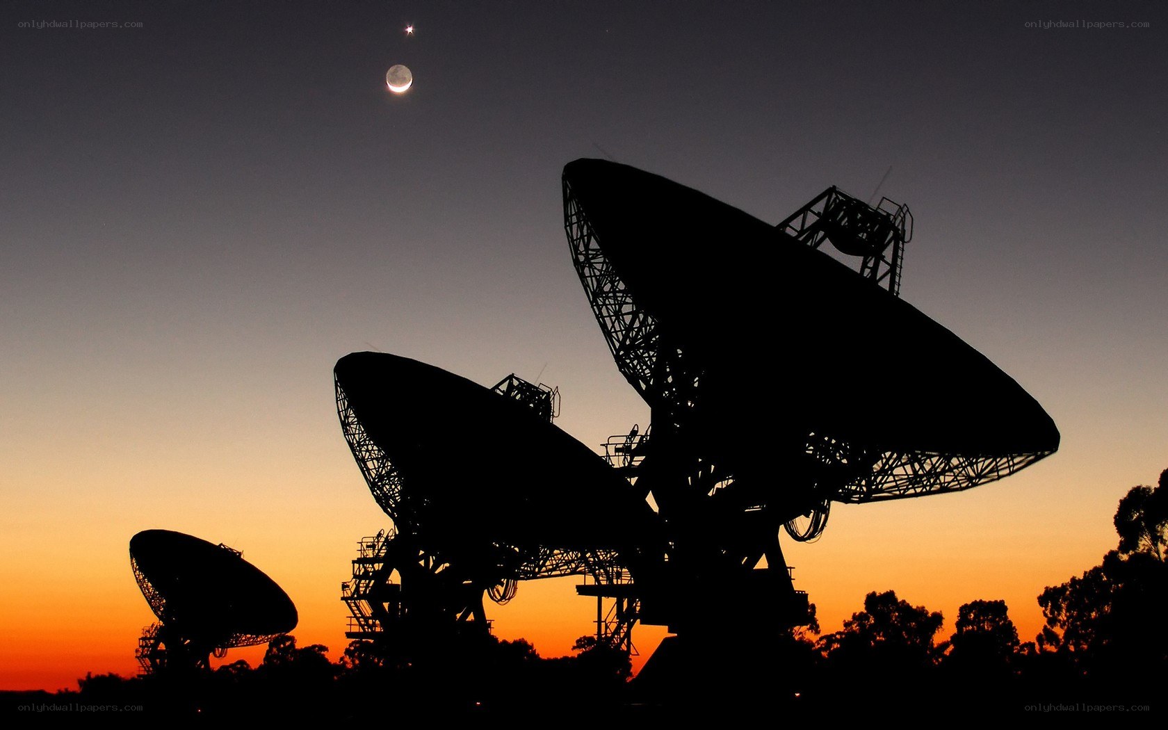 Satellite dishes at sunset