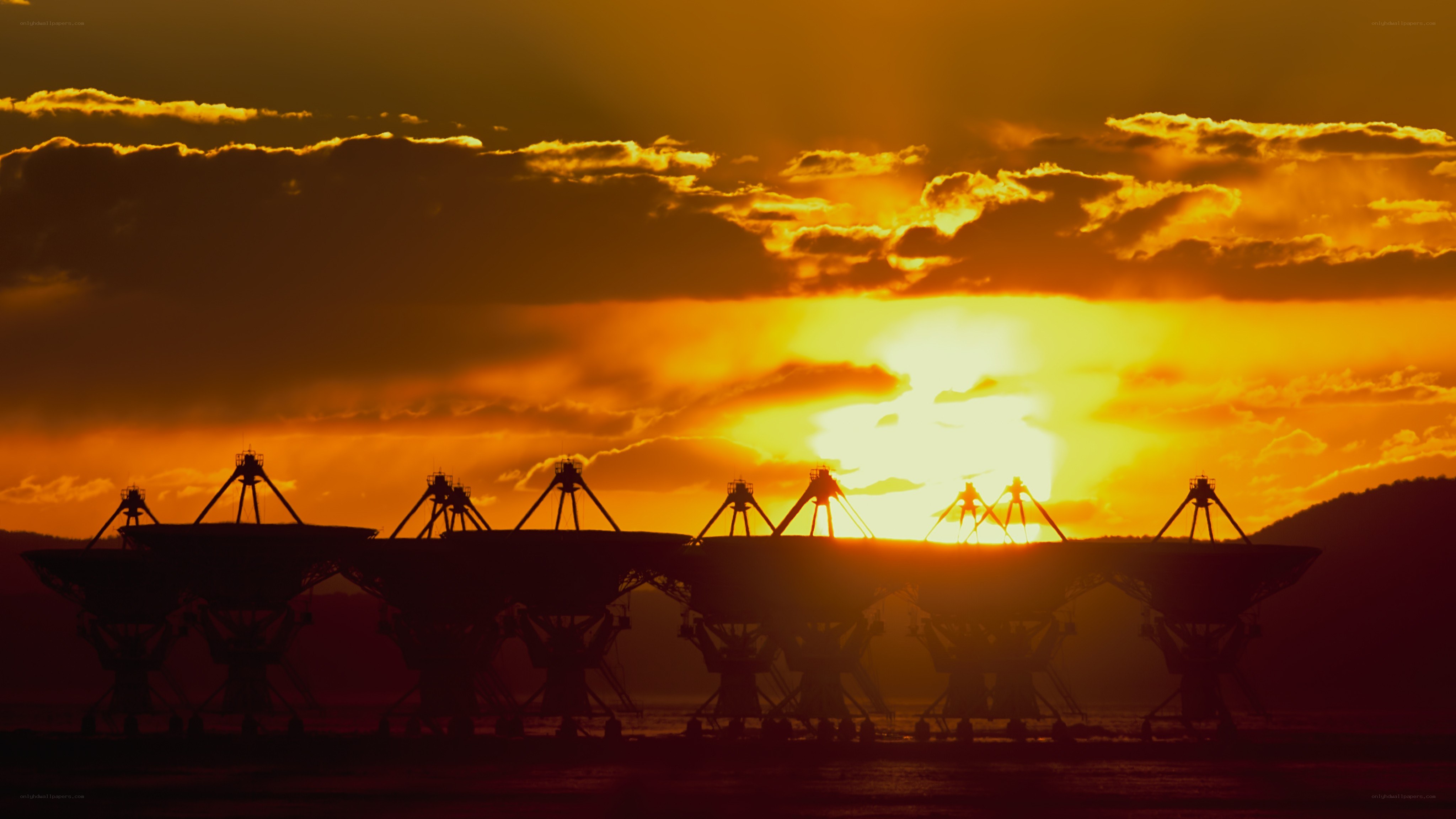 Satellite dishes at sunset