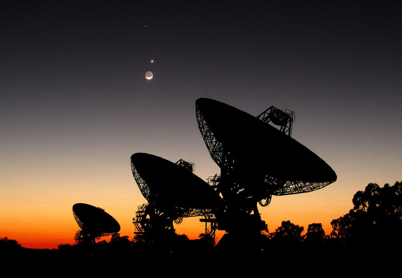 Satellite dishes at sunset