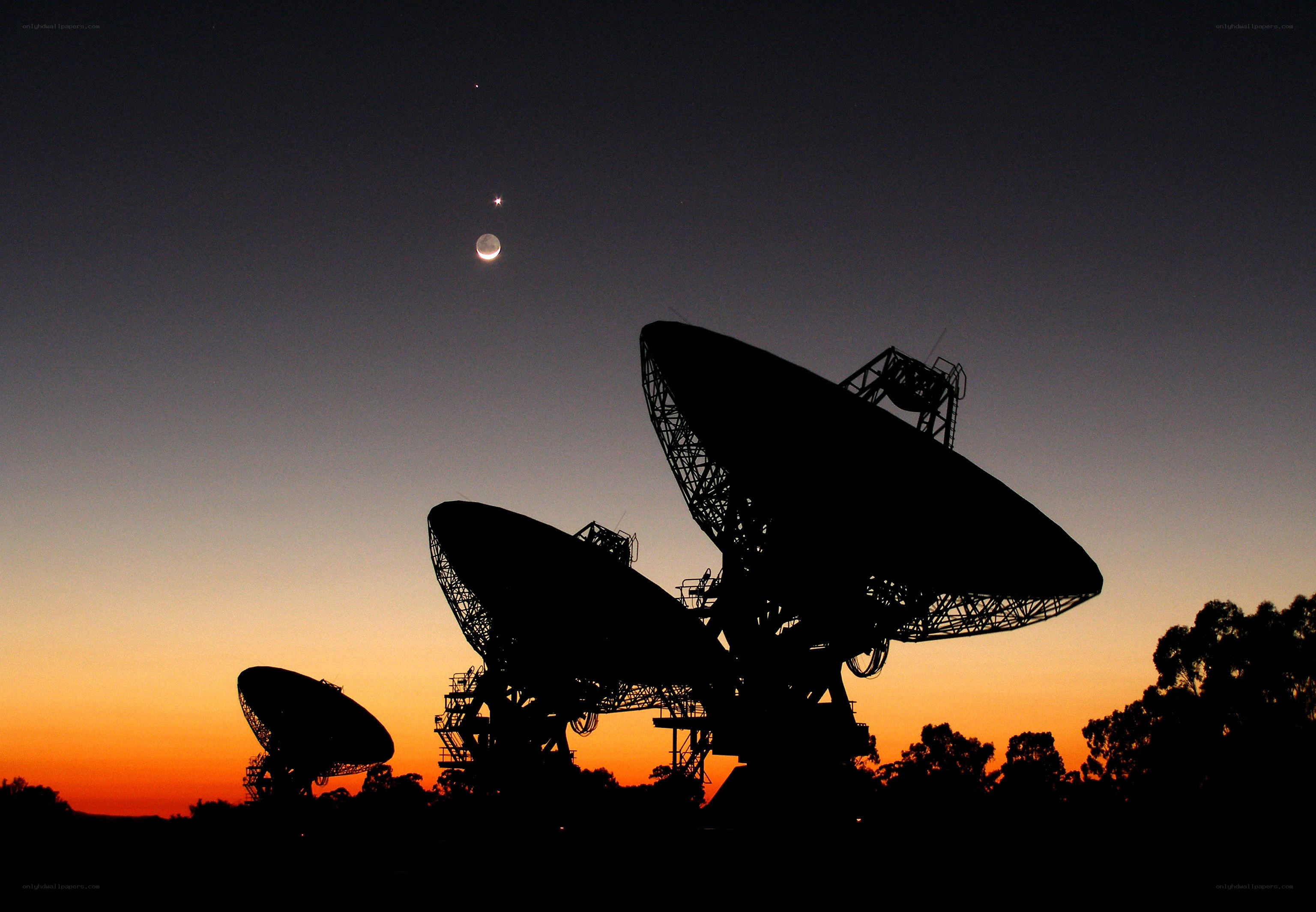 Satellite dishes at sunset