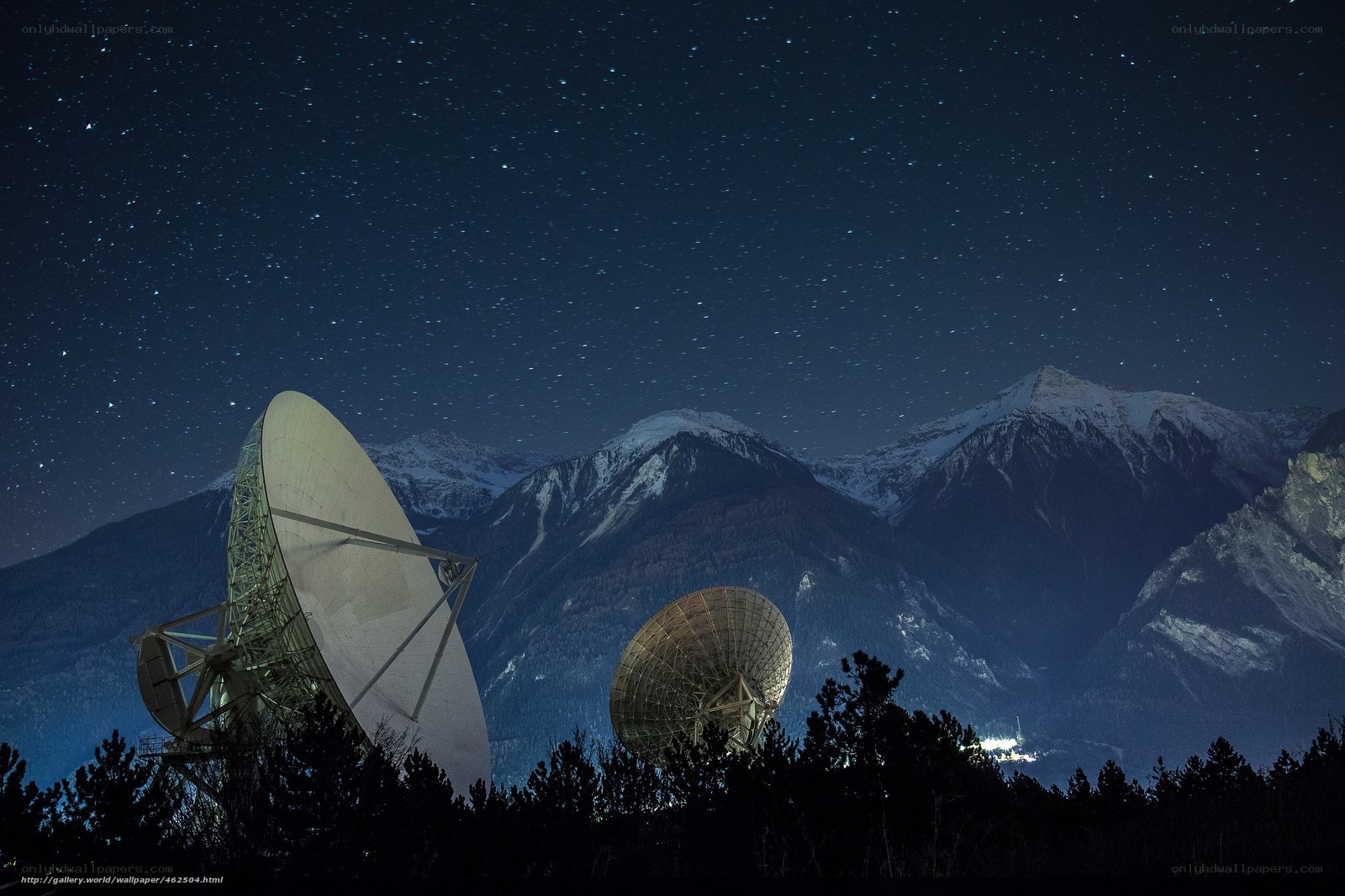 Satellite dishes under starry sky