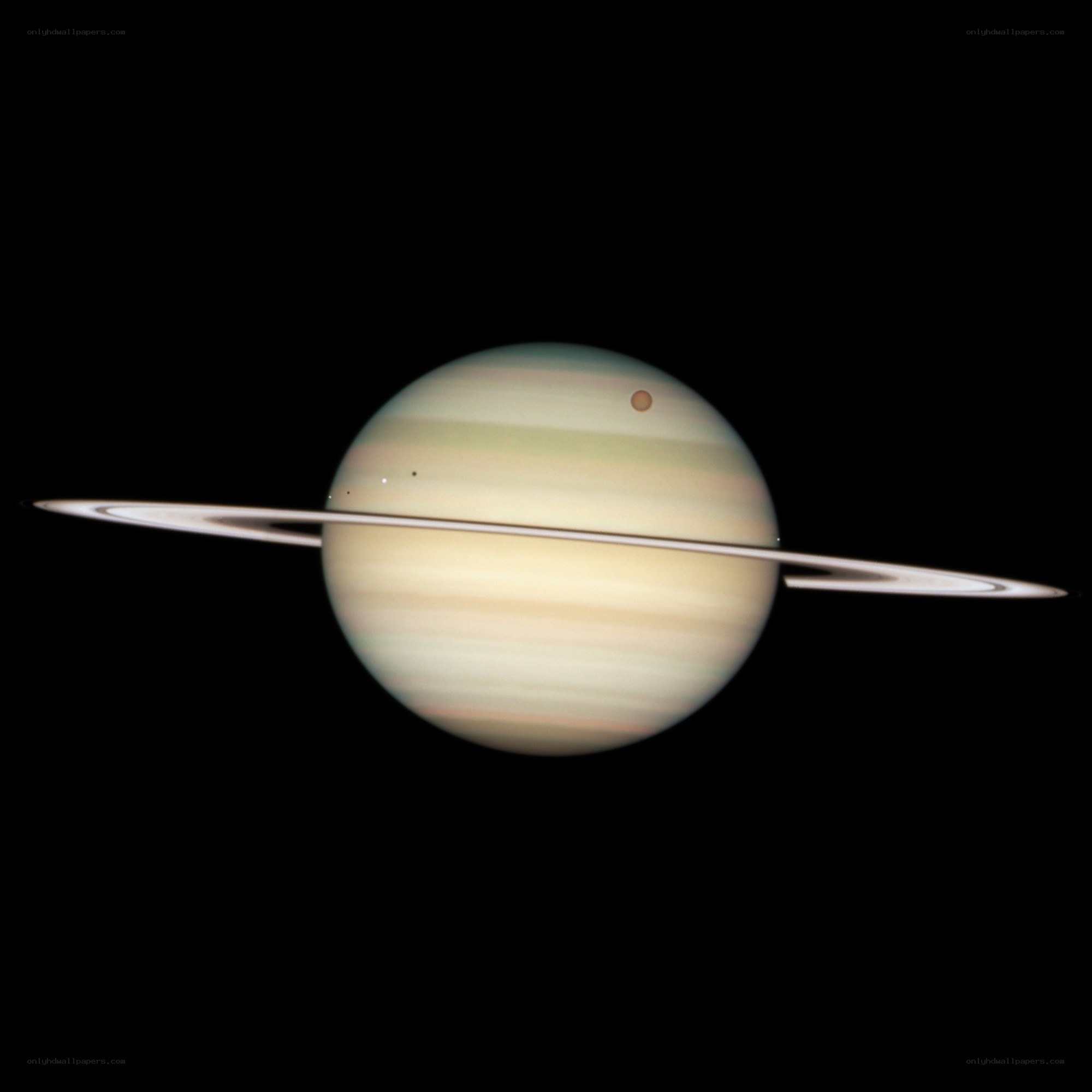 Saturn with its rings and moon