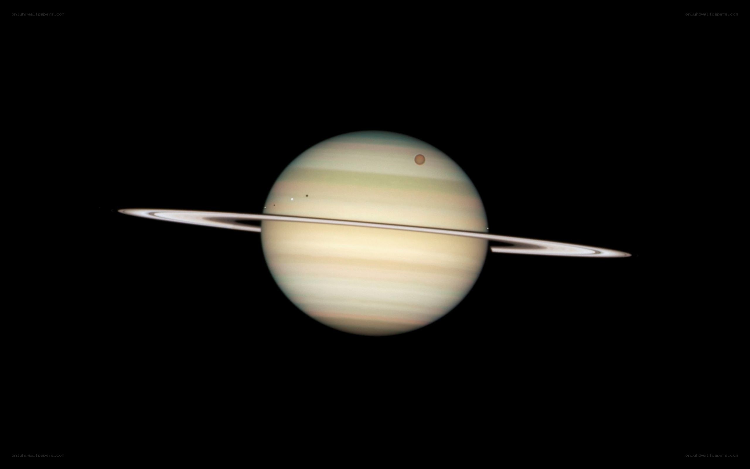 Saturn with its rings and moons