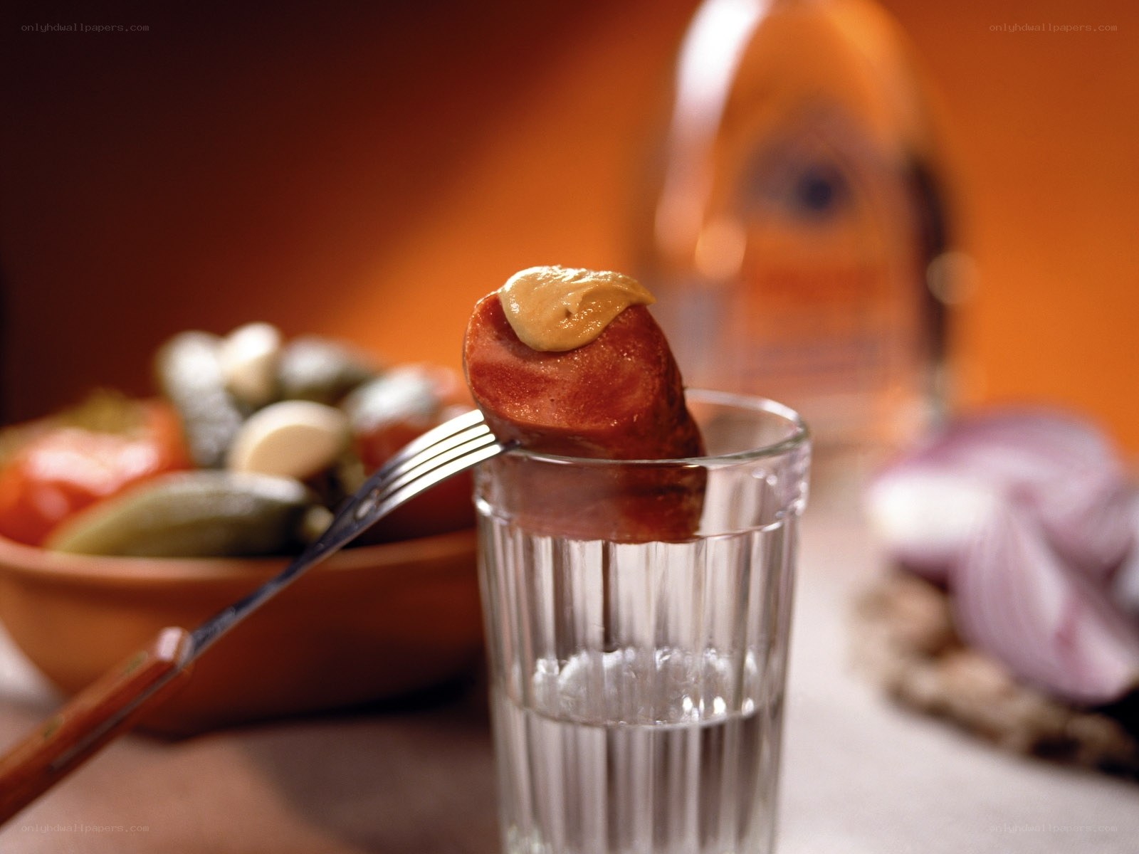 Sausage on a fork with mustard