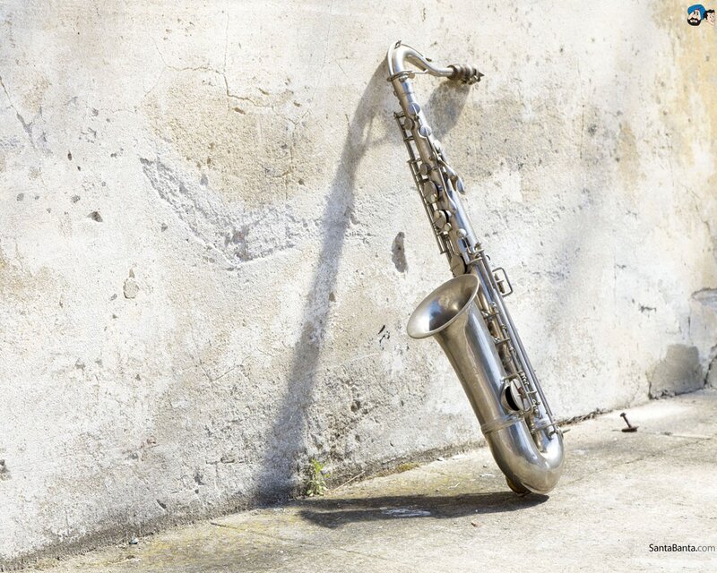 Saxophone leaning against a wall