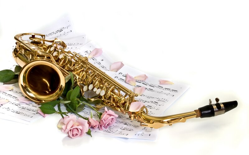 Saxophone with sheet music and roses