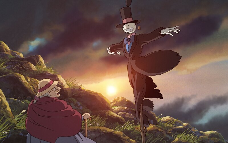 Scarecrow and old woman at sunset