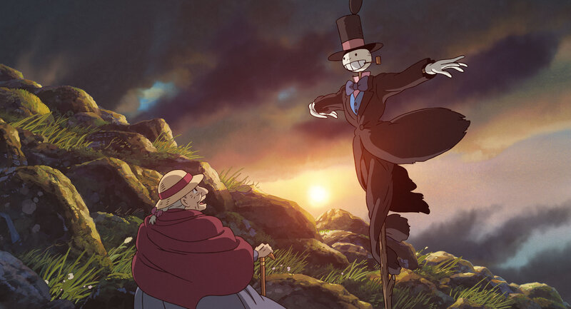 Scarecrow and old woman at sunset