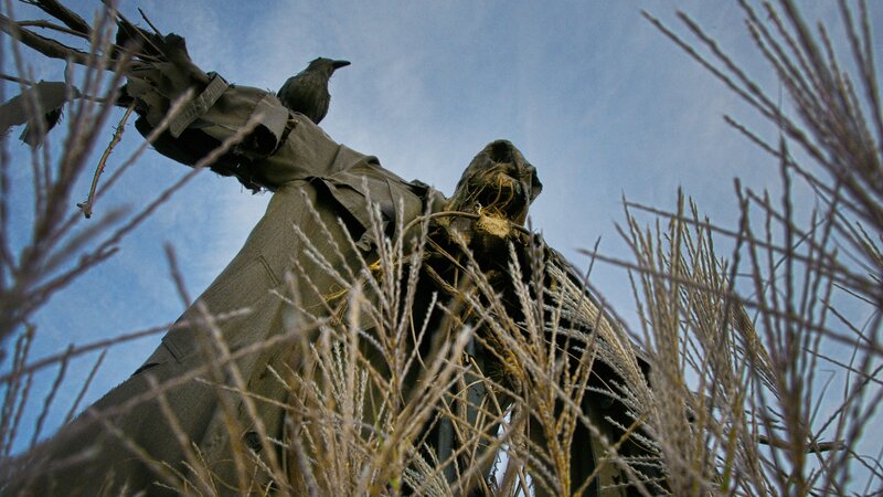 Scarecrow with crow perched