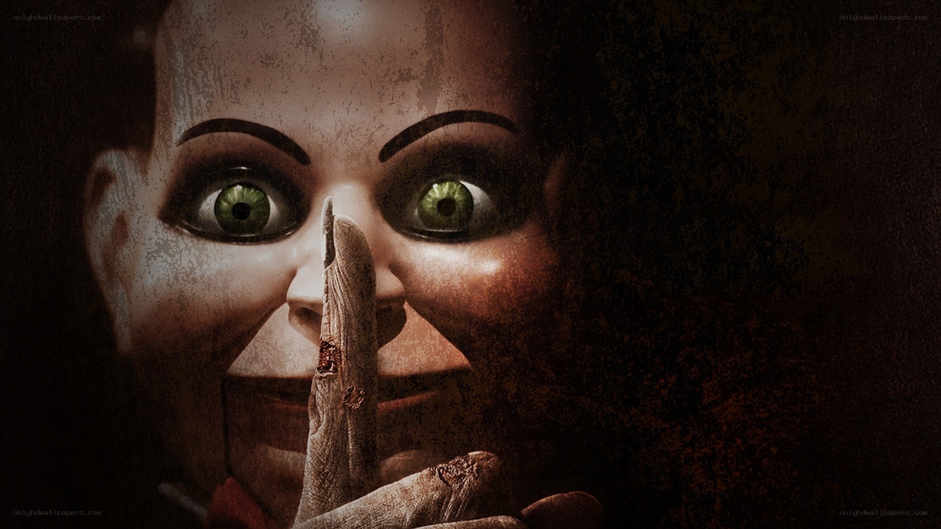 scary doll with finger on lips