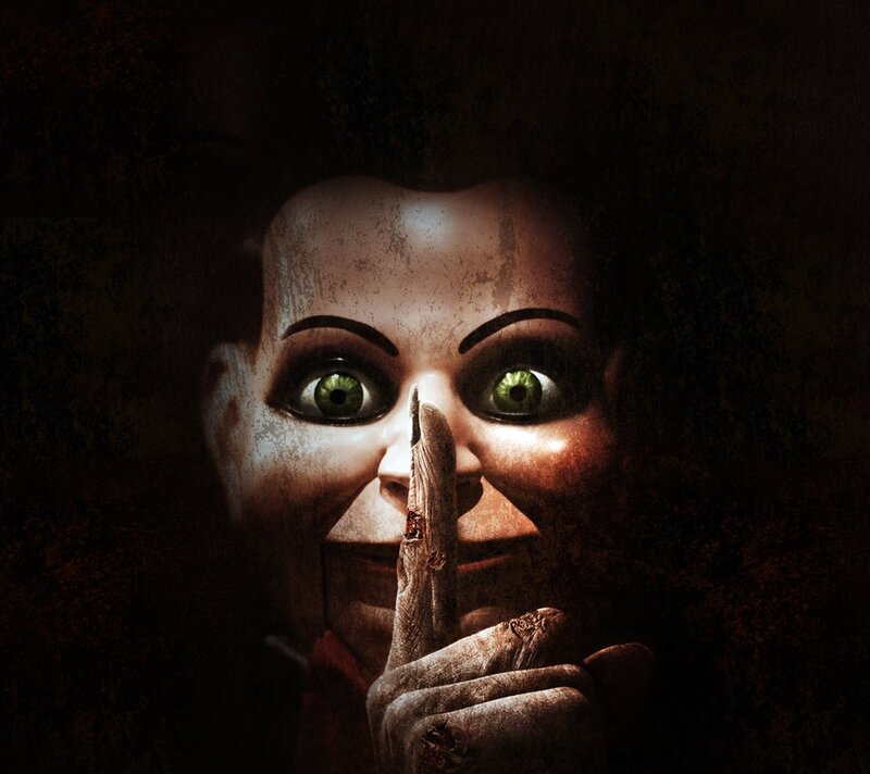 scary doll with finger to mouth