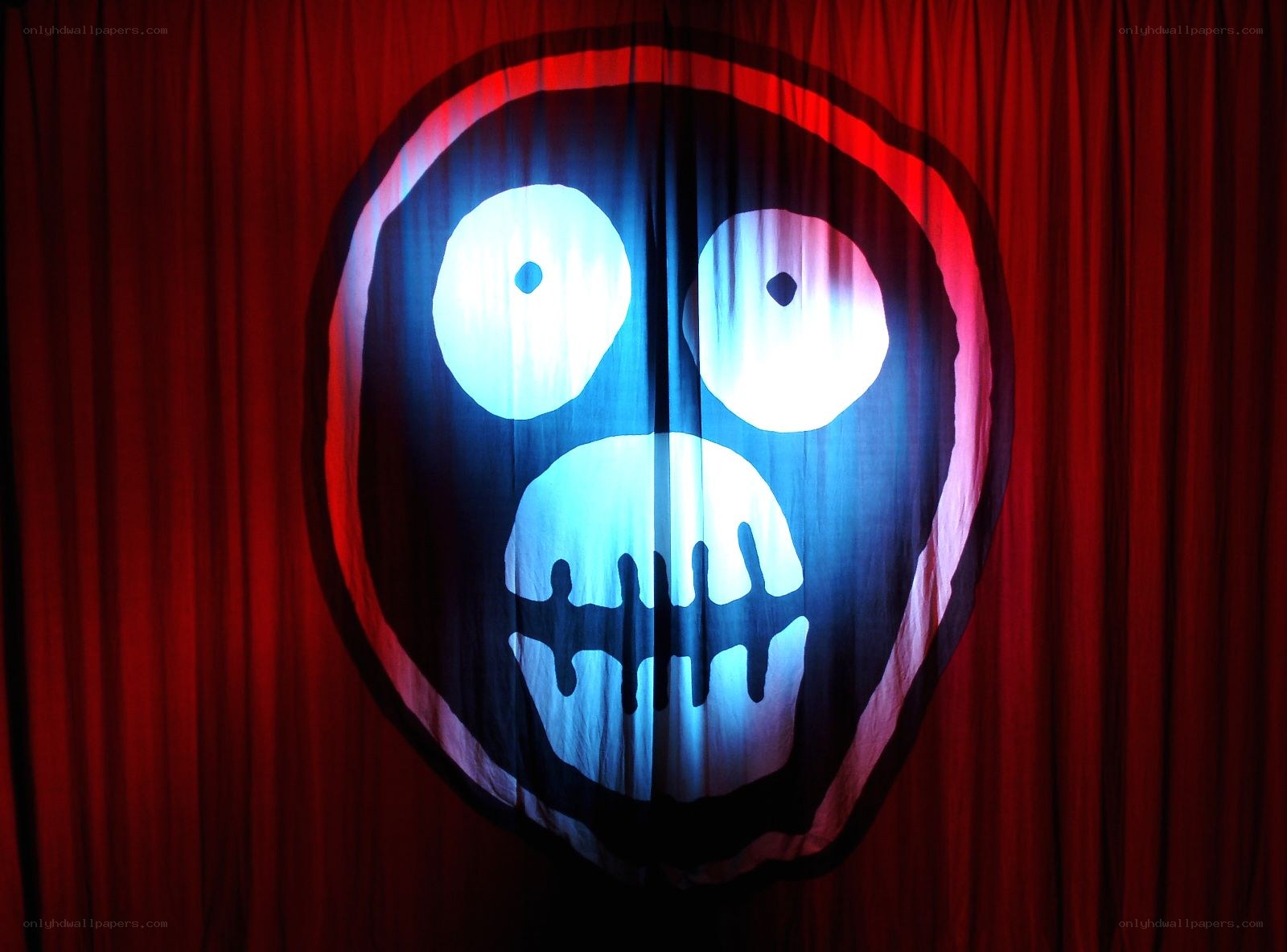 scary face on red curtain
