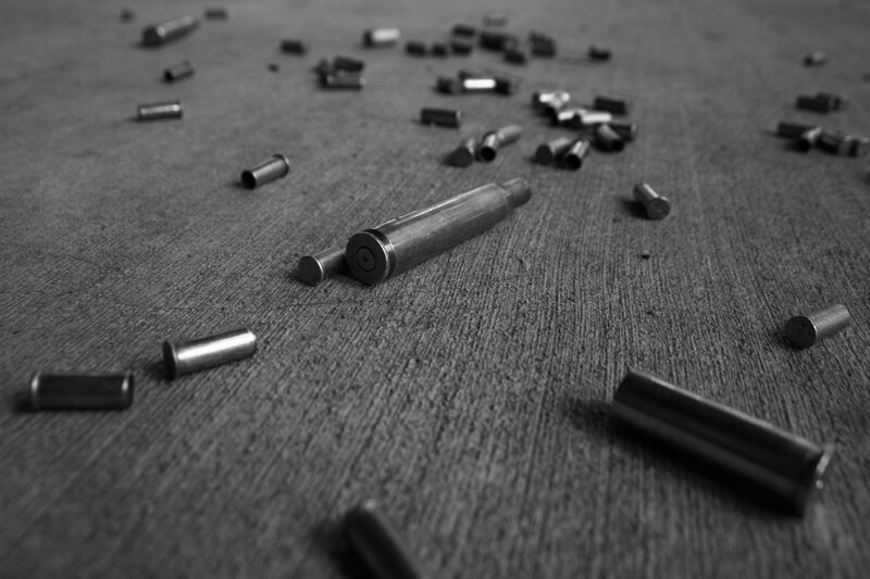 Scattered bullet casings on wood