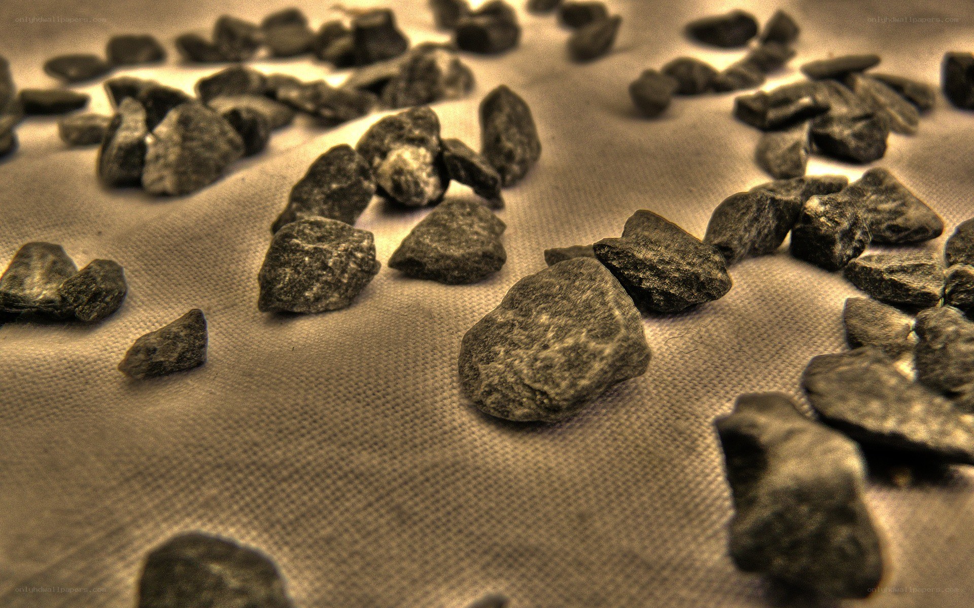scattered dark stones on fabric