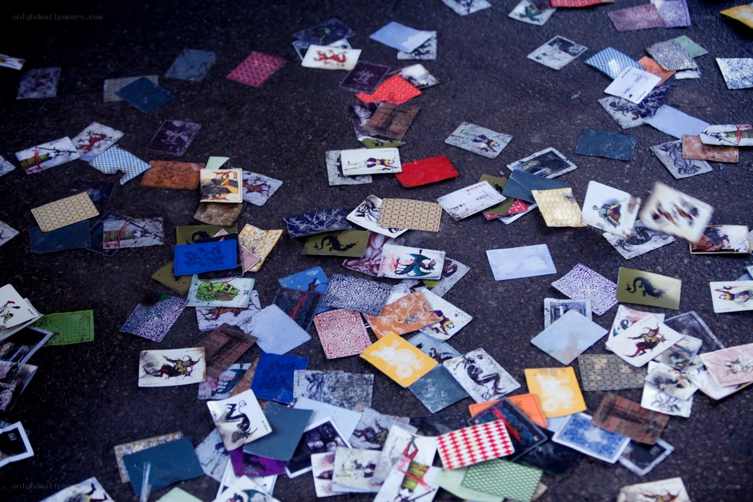 scattered playing cards on pavement